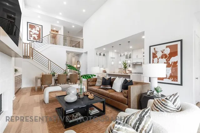 a living room with furniture kitchen view and a window
