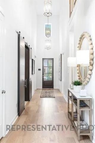 a view of hall way with mirror and furniture