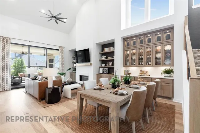 a living room with fireplace furniture and a large window