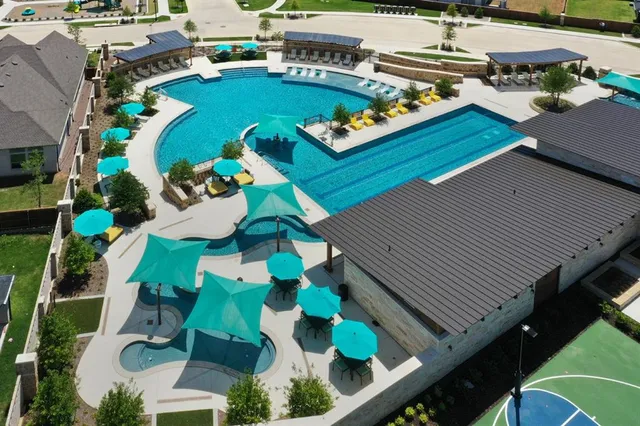 an aerial view of a house yard swimming pool and outdoor seating