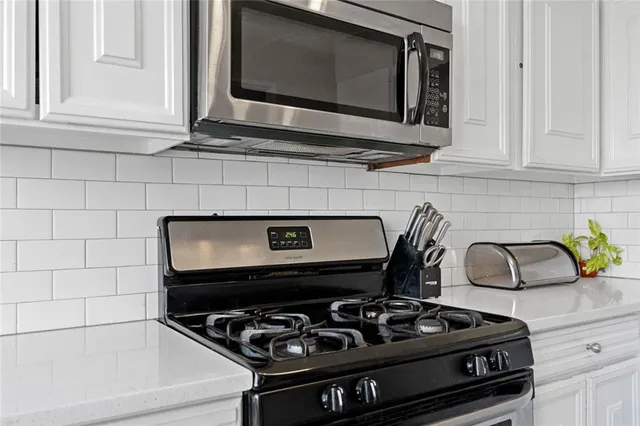 a kitchen with a stove and a microwave