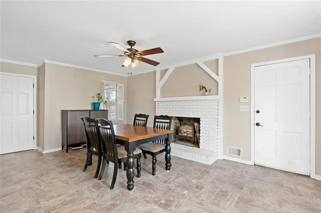 a view of a dining room with furniture and a chandelier