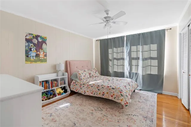 a bedroom with a bed a couch and a window