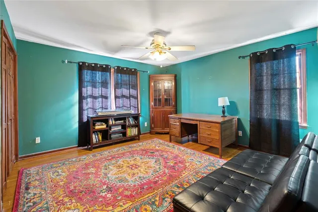 a living room with furniture and a fireplace with wooden floor