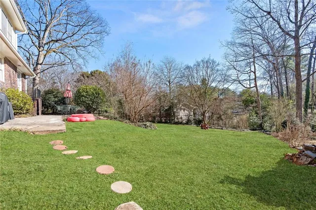a backyard of a house with table and chairs