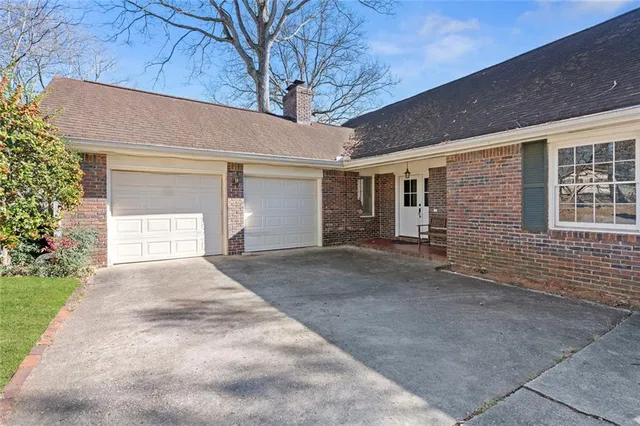 a view of a house with a yard and garage