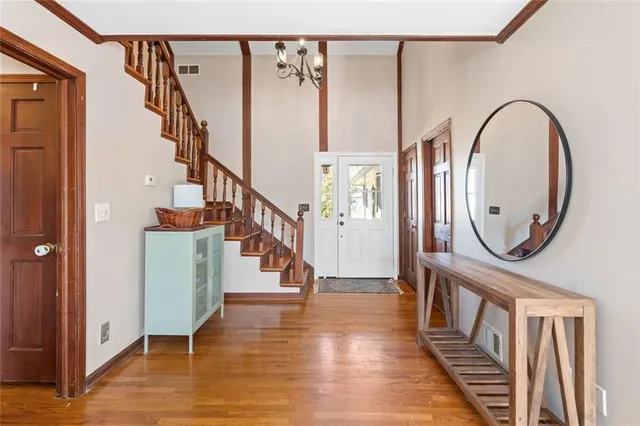 a view of entryway and hall with wooden floor