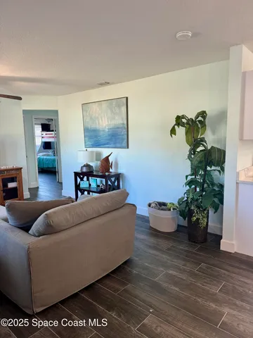 a living room with furniture and flowers