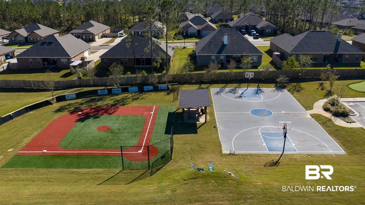32125 Lyon Road Daphne, AL 36527 - Photo 65 of 70 Community sports amenities featuring a baseball field with artificial turf, a full basketball court with two hoops, and a shaded picnic area