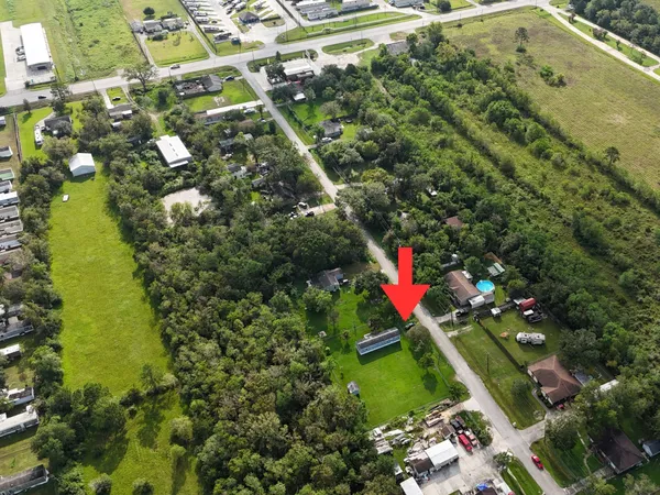 an aerial view of residential houses with outdoor space and swimming pool