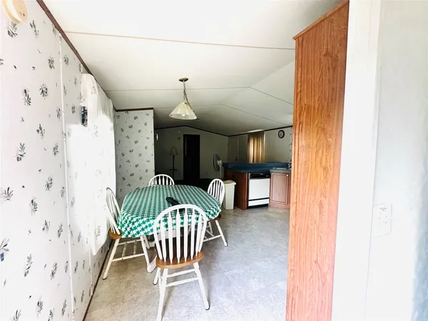 a view of a hallway with furniture and front door