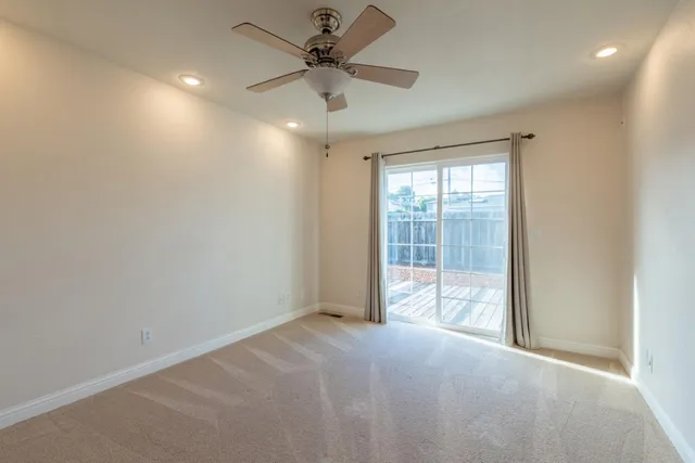 a view of a livingroom with a ceiling fan and window