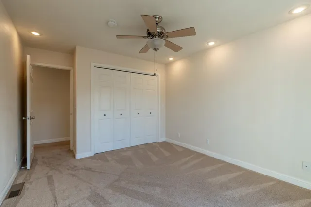 en empty room with a ceiling fan and a ceiling fan