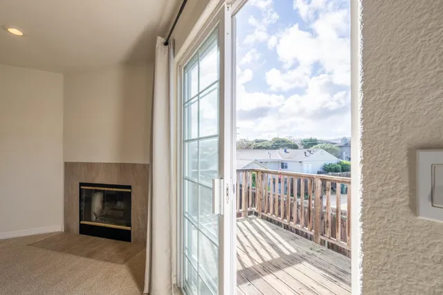 a view of a livingroom with furniture wooden floor and a fireplace