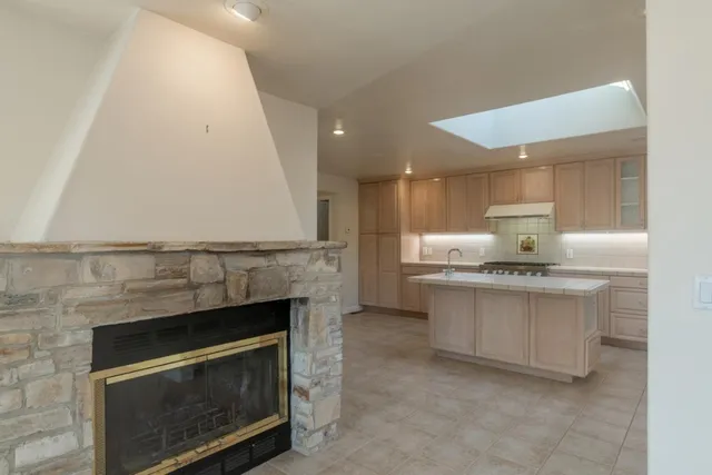 a kitchen with stainless steel appliances granite countertop a stove a sink and a refrigerator