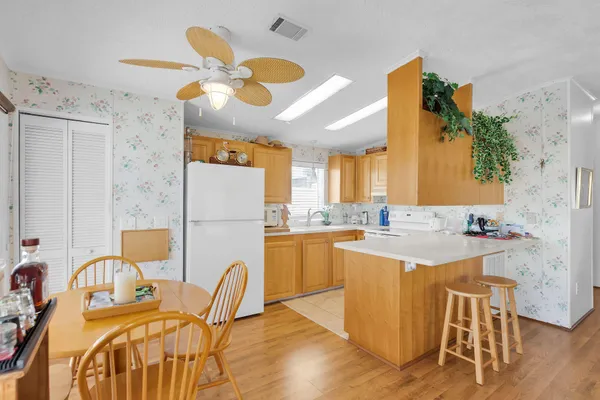 a kitchen with a dining table chairs and white cabinets