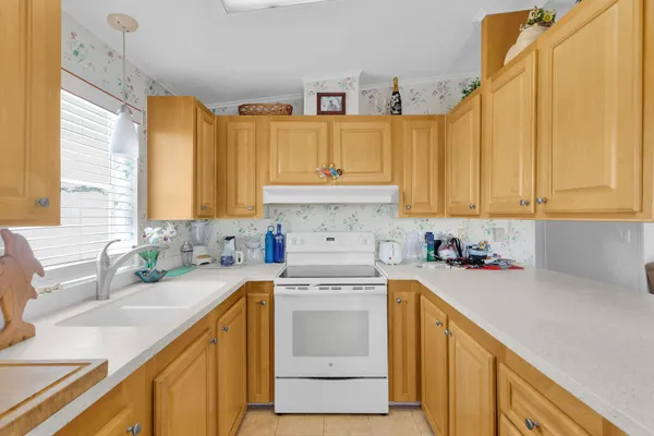 a kitchen with a sink stove and cabinets