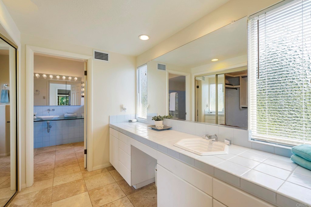 2627 Via Oeste Drive Fallbrook, CA 92028 - Photo 11 of 41 a bathroom with a granite countertop sink and a mirror