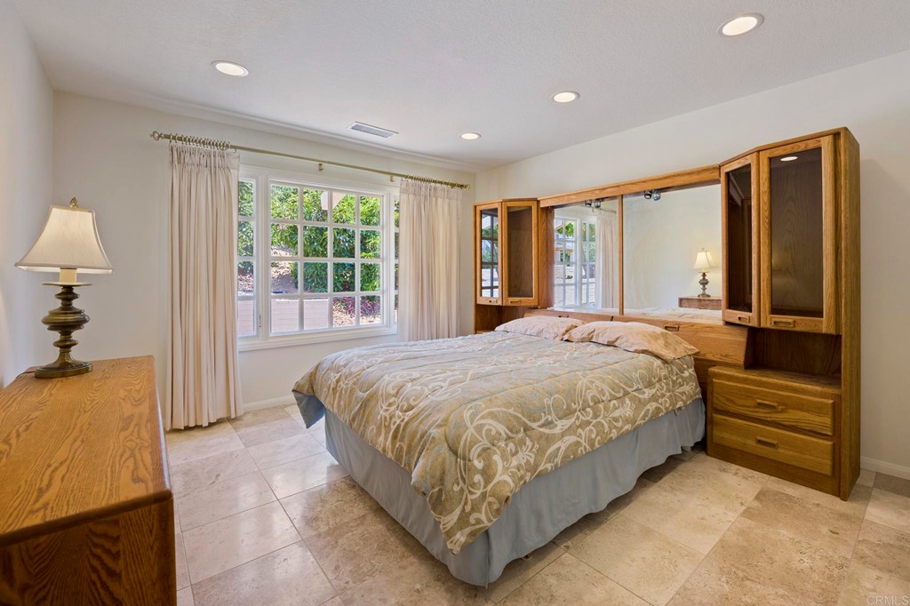 2627 Via Oeste Drive Fallbrook, CA 92028 - Photo 13 of 41 a spacious bedroom with a large bed and a dresser next to a window
