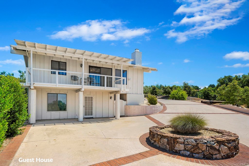 2627 Via Oeste Drive Fallbrook, CA 92028 - Photo 18 of 41 a view of a white building with a fountain