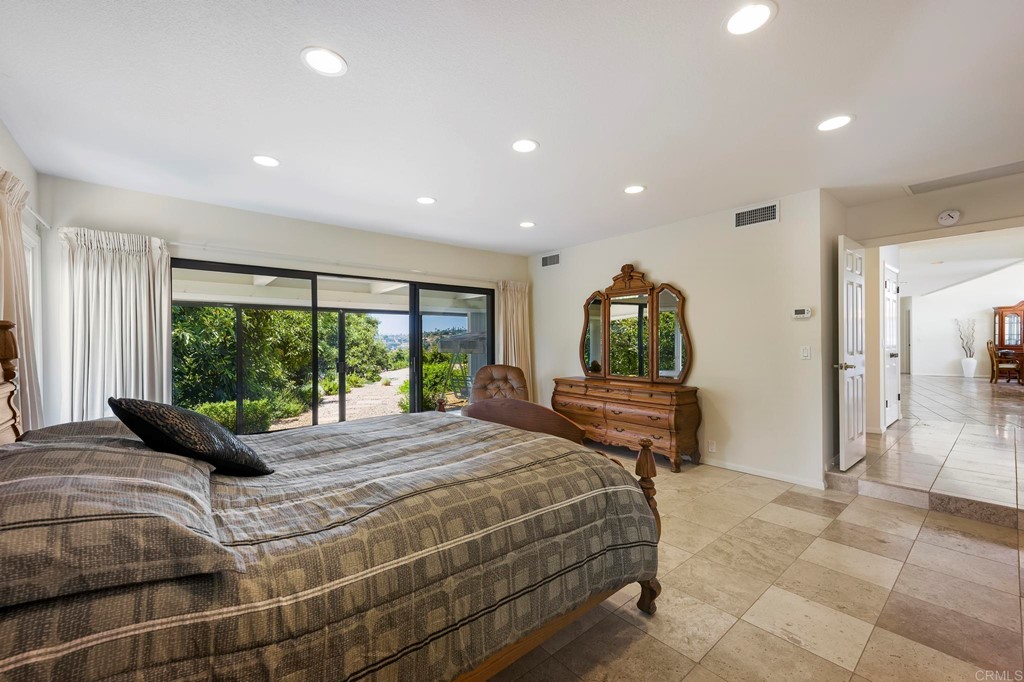 2627 Via Oeste Drive Fallbrook, CA 92028 - Photo 30 of 41 a bed sitting in a spacious bedroom next to a window