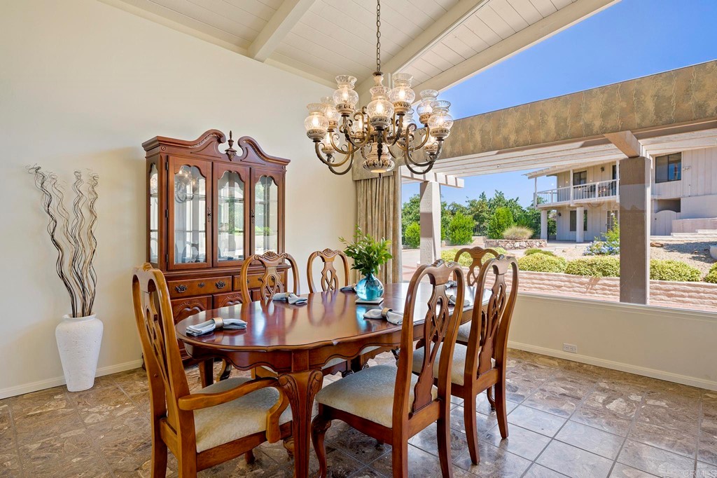 2627 Via Oeste Drive Fallbrook, CA 92028 - Photo 32 of 41 a view of a dining room with furniture a chandelier and large windows