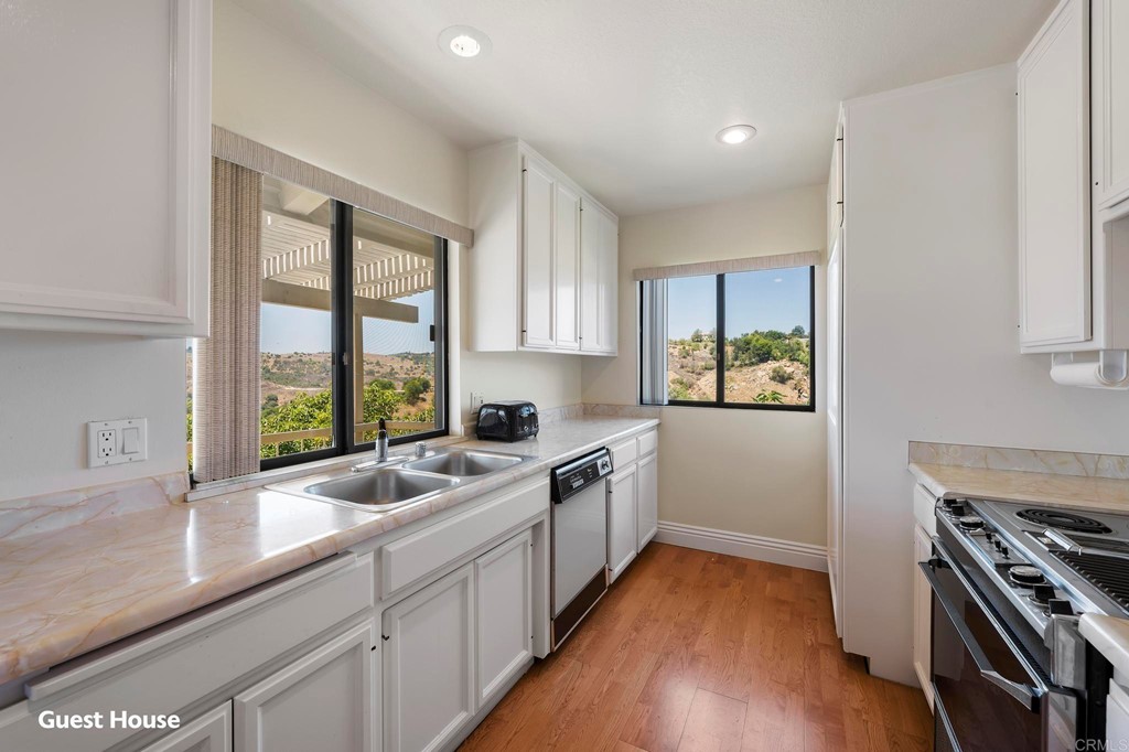 2627 Via Oeste Drive Fallbrook, CA 92028 - Photo 36 of 41 a kitchen with a sink stove and cabinets