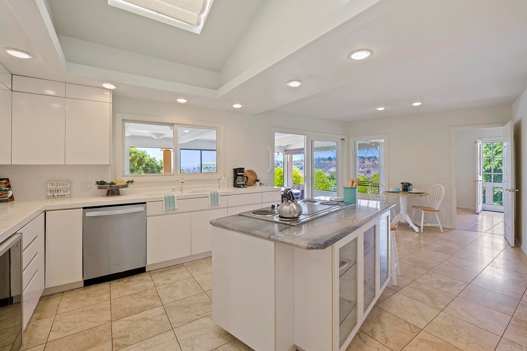 2627 Via Oeste Drive Fallbrook, CA 92028 - Photo 8 of 41 a kitchen with stainless steel appliances kitchen island granite countertop a sink and cabinets