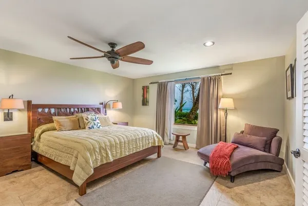 a bedroom with a bed and a couch