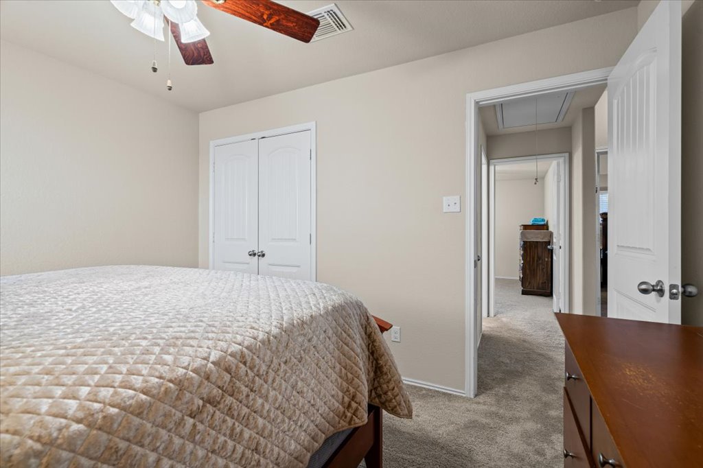 212 Plata Lane Jarrell, TX 76537 - Photo 23 of 30 Bedroom featuring a closet, carpet, and a ceiling fan