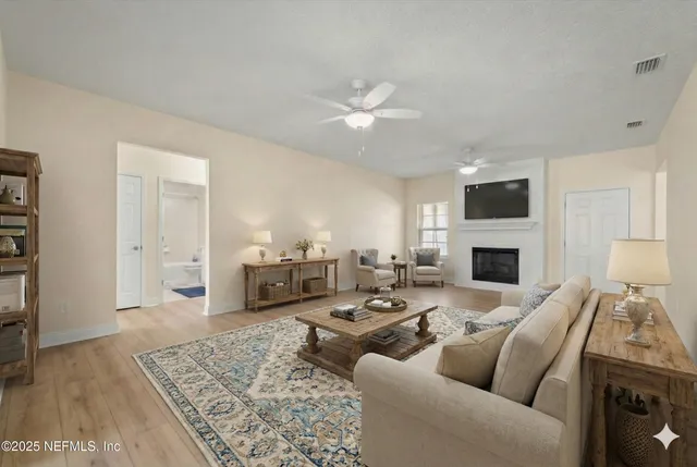 a living room with furniture a fireplace and a table