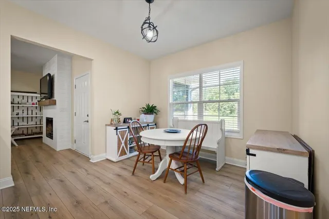a view of a dining room with furniture and wooden floor