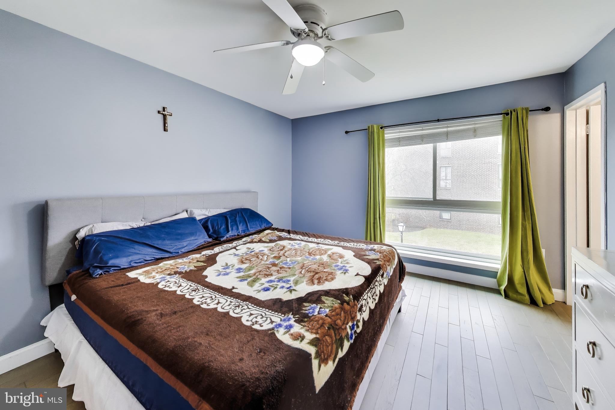 3206 Spartan Road, Unit 17 Olney, MD 20832 - Photo 11 of 28 a bedroom with a bed and a chandelier