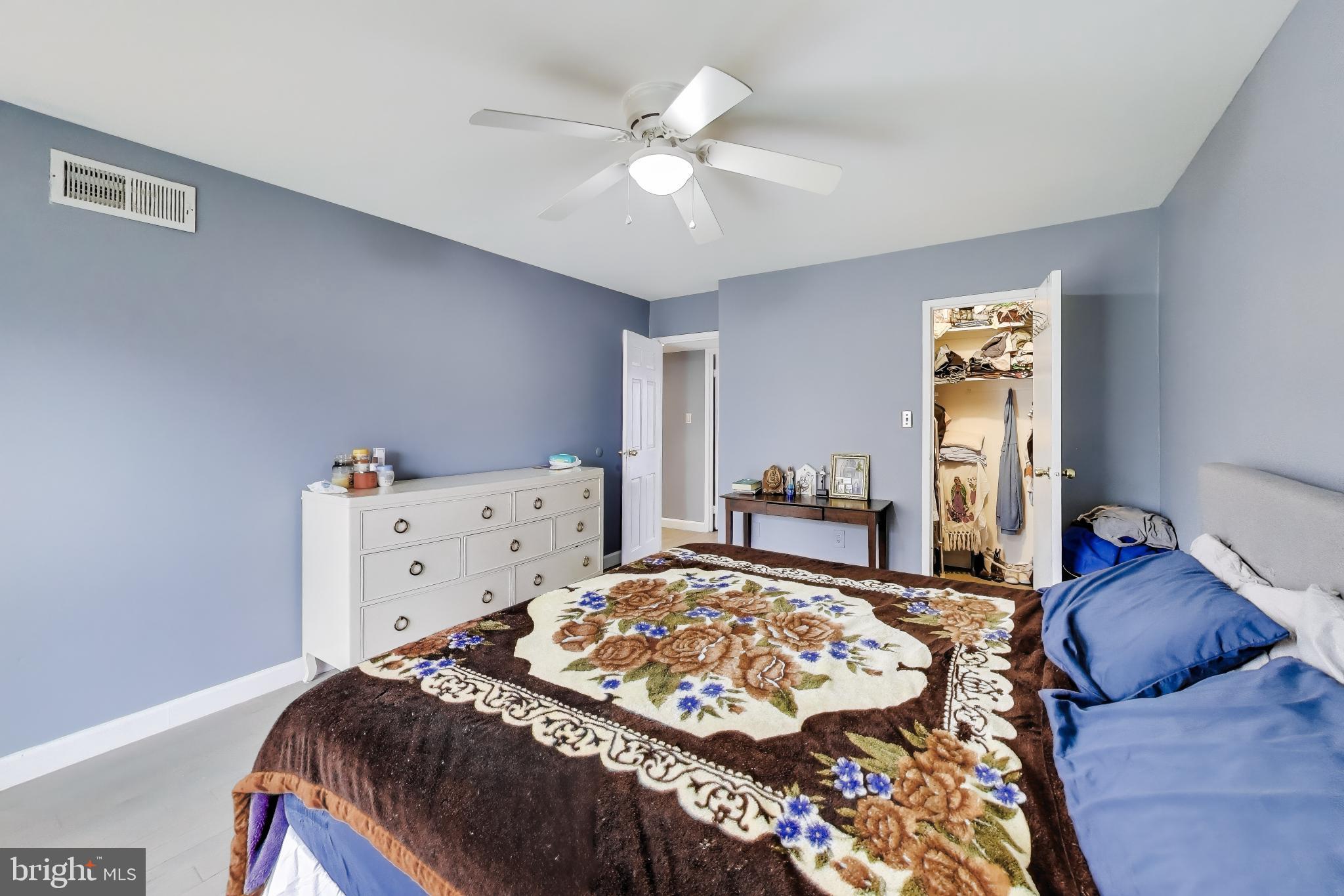3206 Spartan Road, Unit 17 Olney, MD 20832 - Photo 13 of 28 a bedroom with a bed and a chandelier