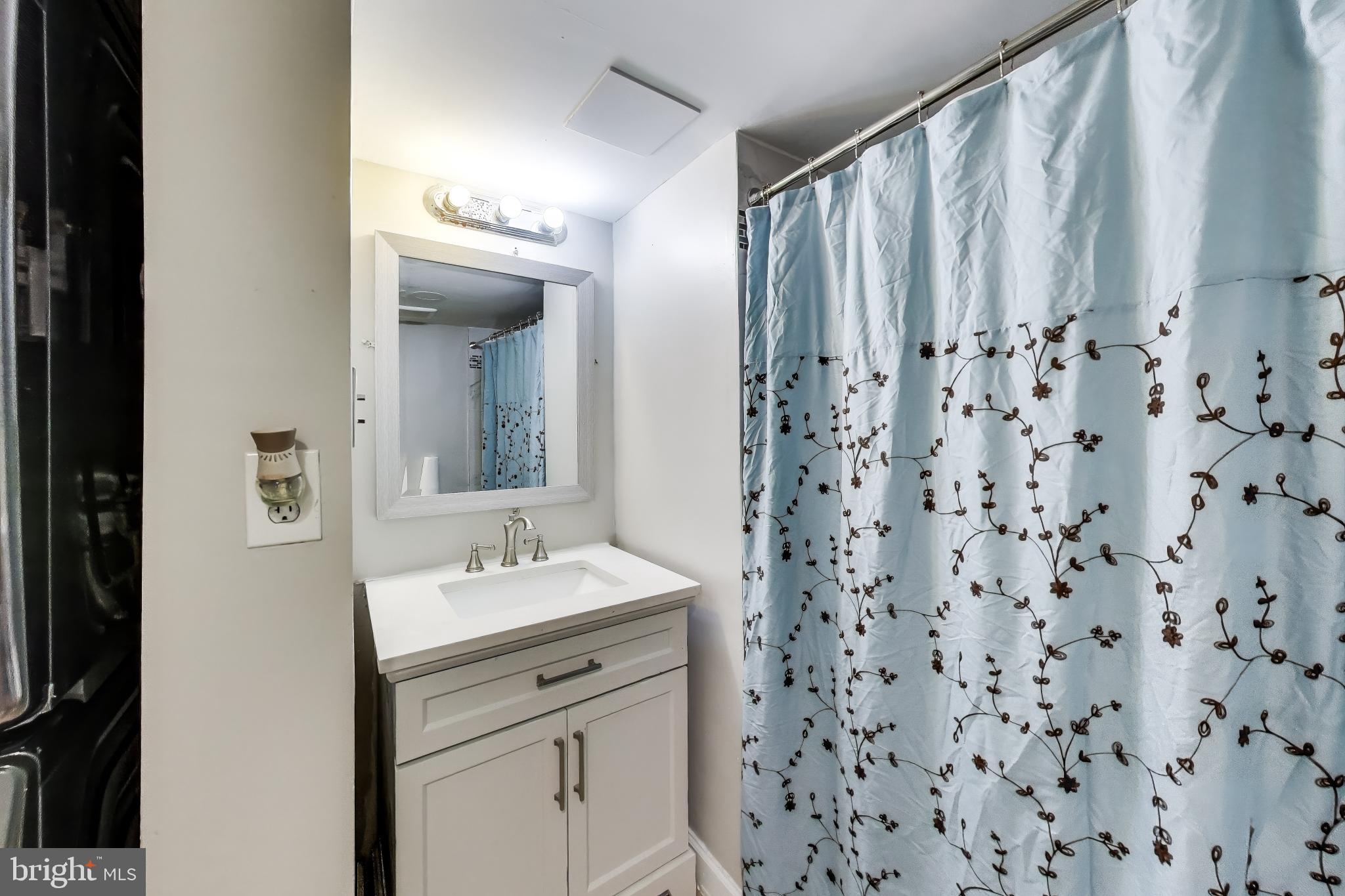 3206 Spartan Road, Unit 17 Olney, MD 20832 - Photo 19 of 28 a bathroom with a sink and a mirror