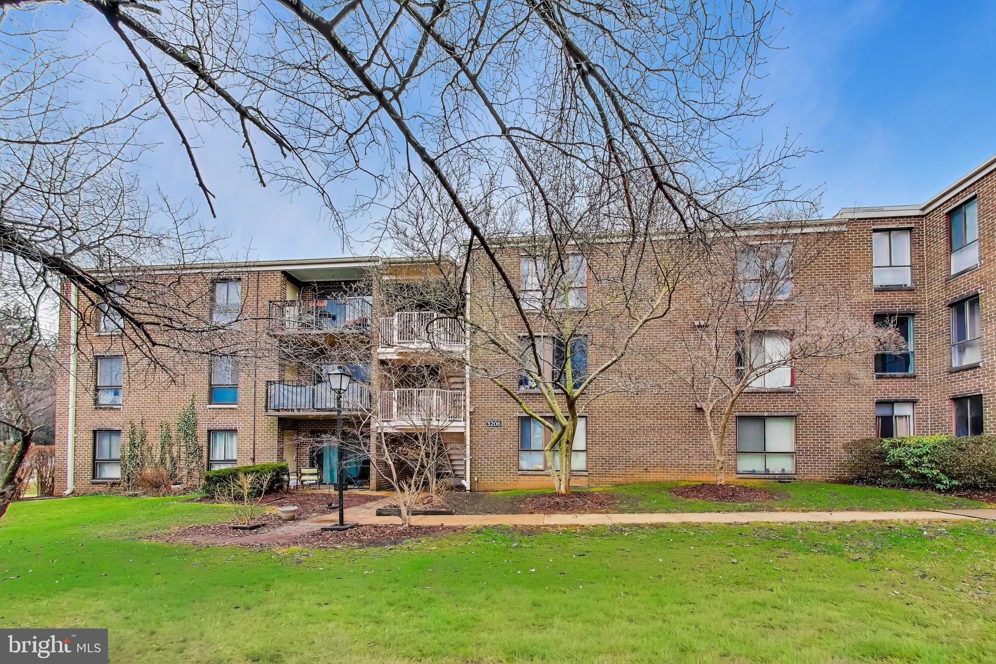 3206 Spartan Road, Unit 17 Olney, MD 20832 - Photo 23 of 28 a building view with outdoor seating space and garden