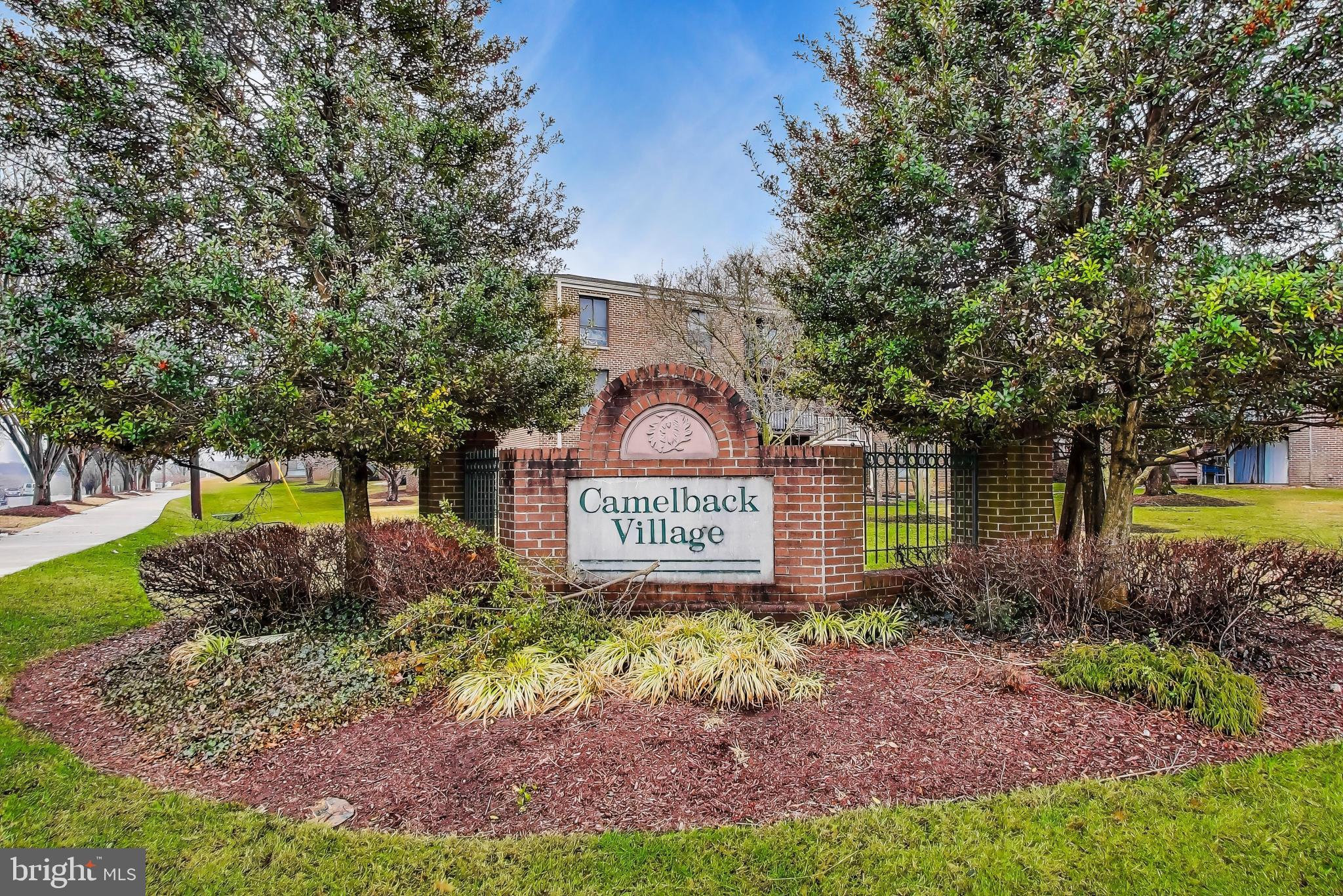 3206 Spartan Road, Unit 17 Olney, MD 20832 - Photo 27 of 28 a sign that is sitting in front of a big yard with large trees