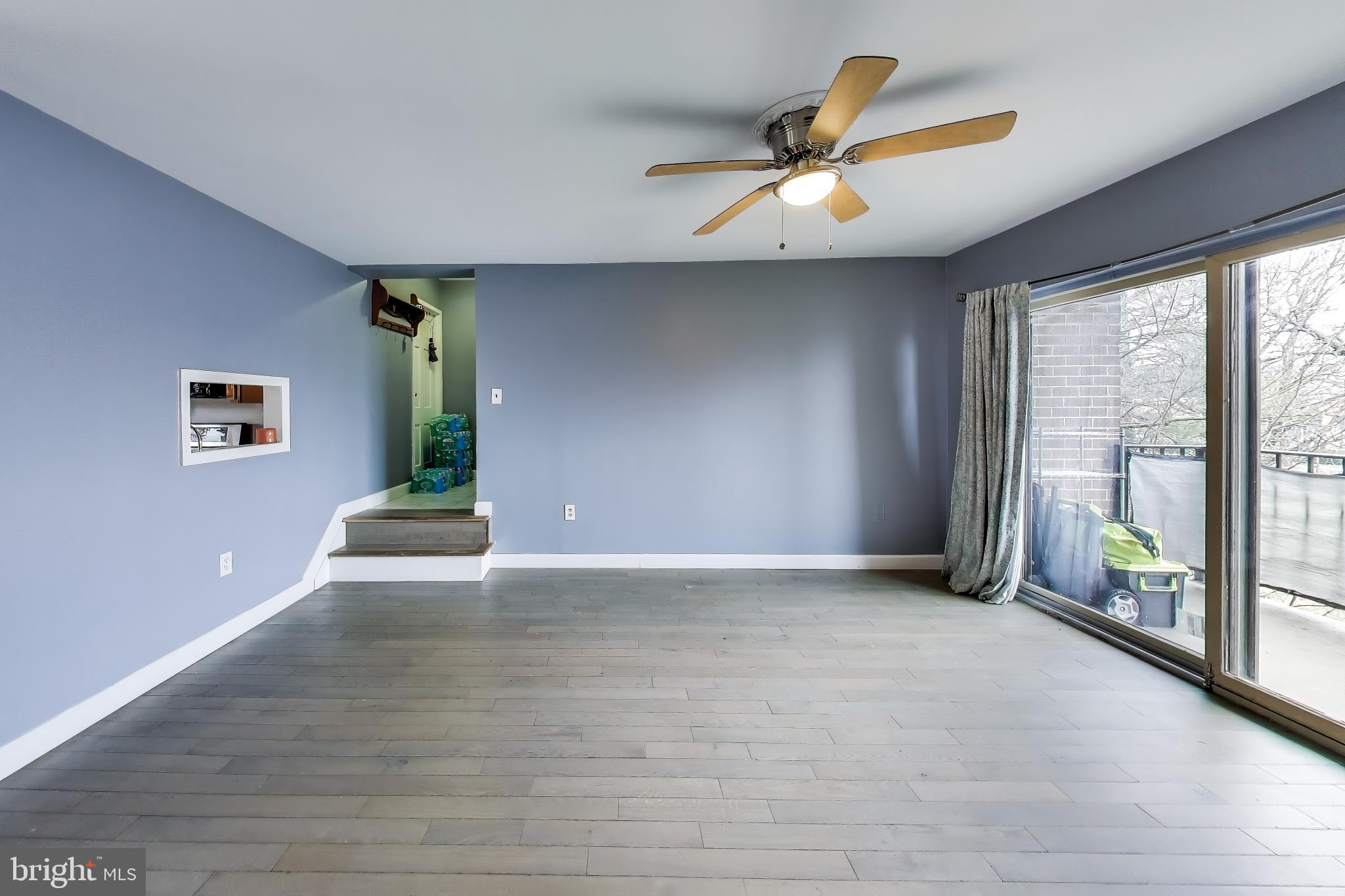 3206 Spartan Road, Unit 17 Olney, MD 20832 - Photo 5 of 28 a view of an empty room with window and wooden floor