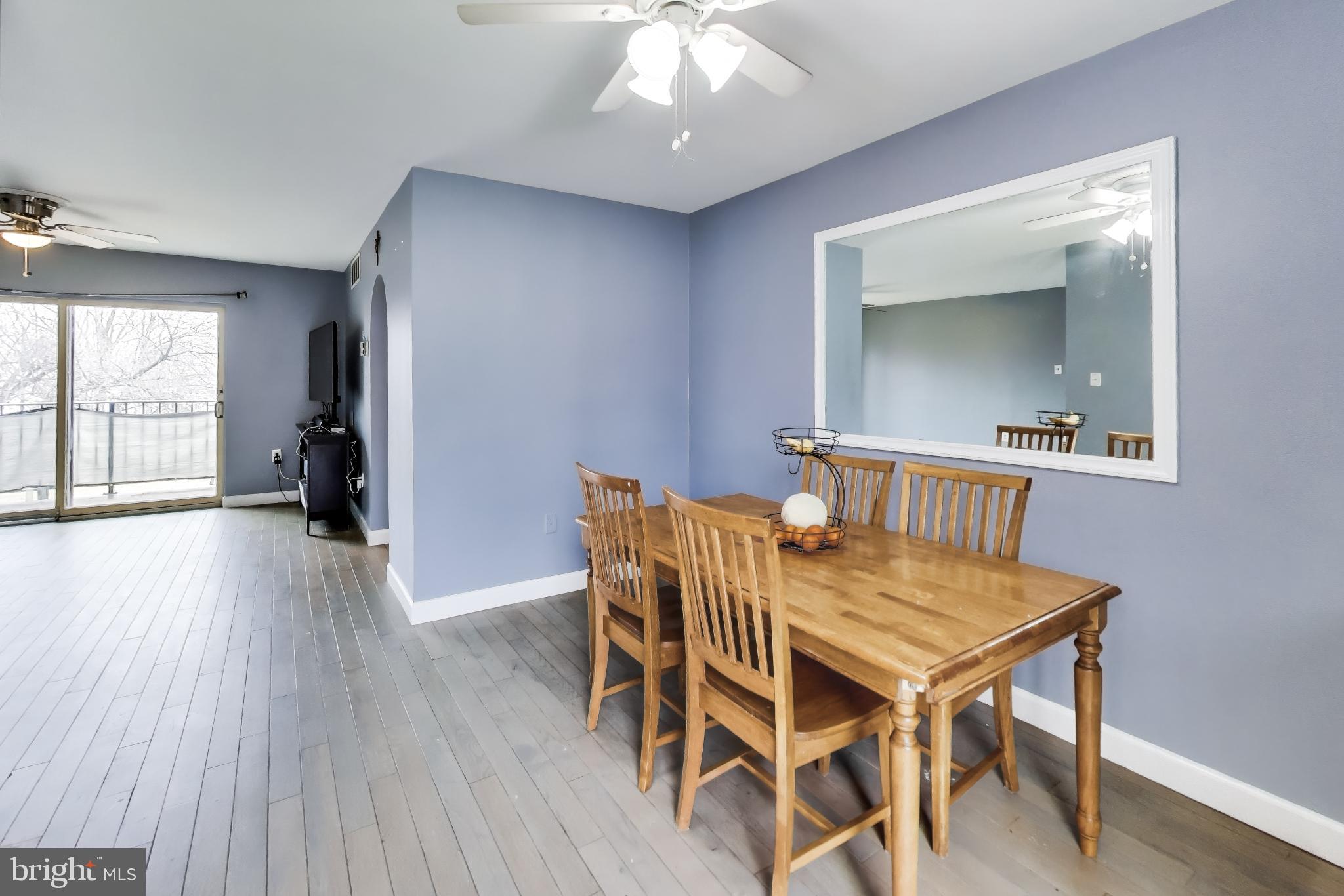 3206 Spartan Road, Unit 17 Olney, MD 20832 - Photo 8 of 28 a view of a dining room with furniture and wooden floor