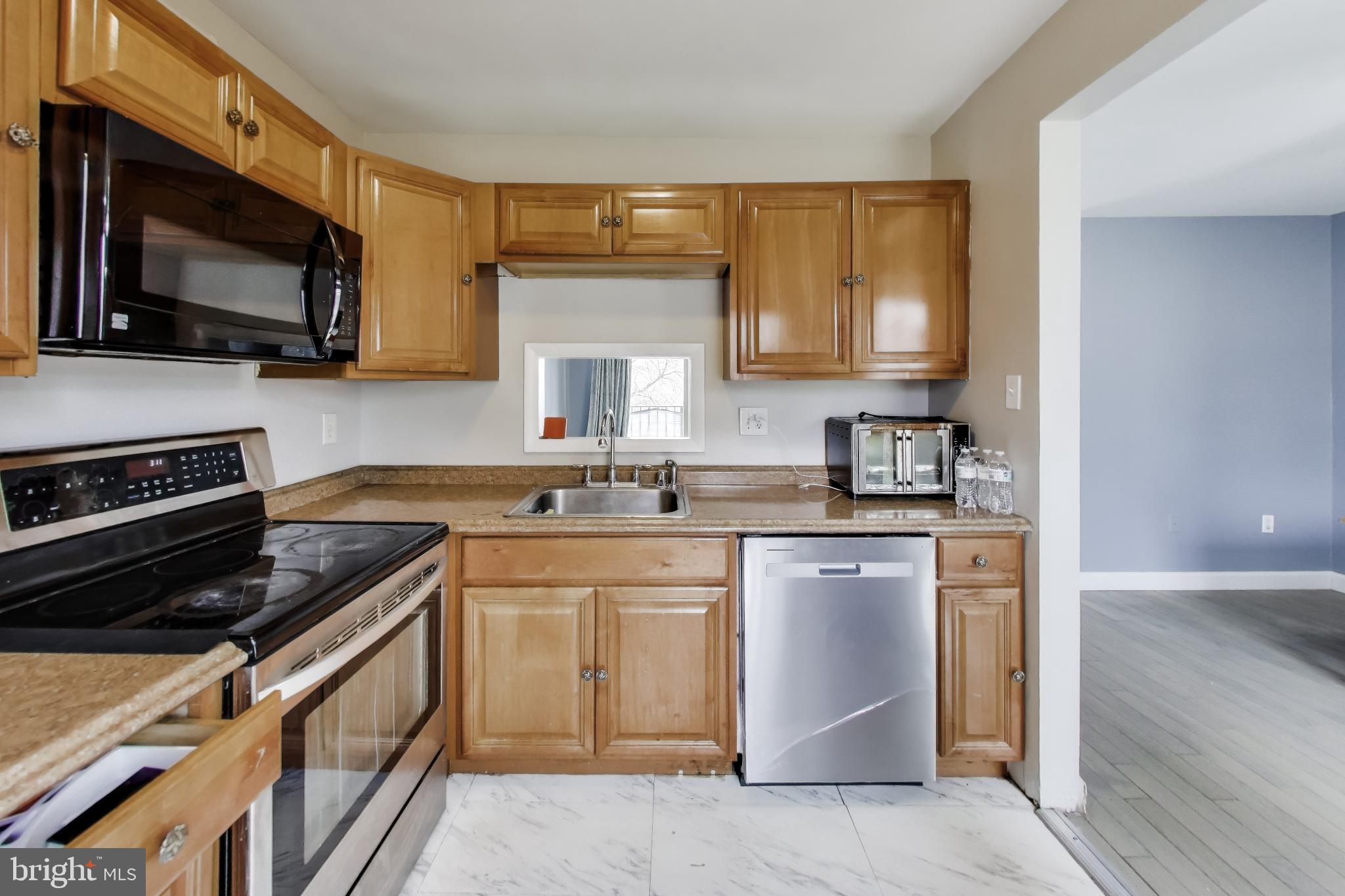 3206 Spartan Road, Unit 17 Olney, MD 20832 - Photo 10 of 28 a kitchen with a sink stove and microwave