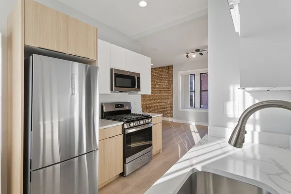 a kitchen with a refrigerator stove and sink