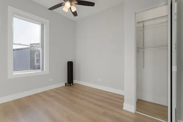 a view of a livingroom with a hardwood floor and a ceiling fan