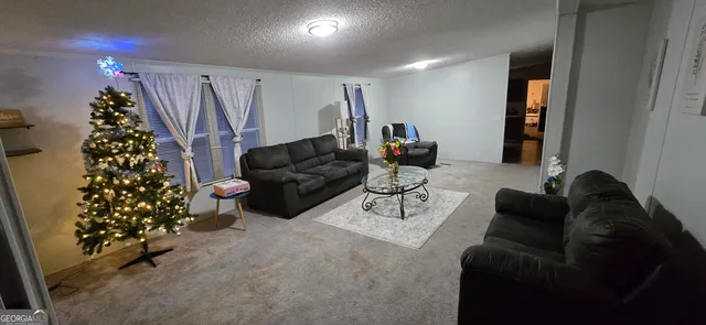 a living room with furniture and a christmas tree