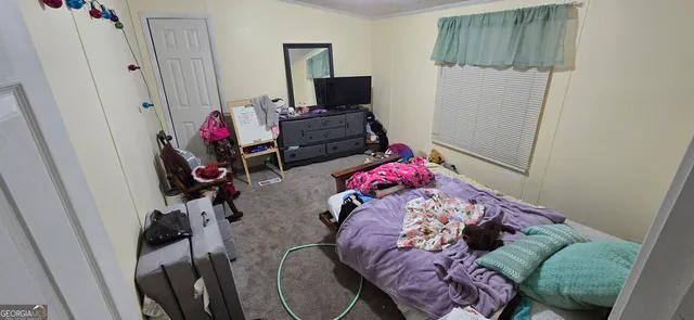 a bedroom with a bed and furniture