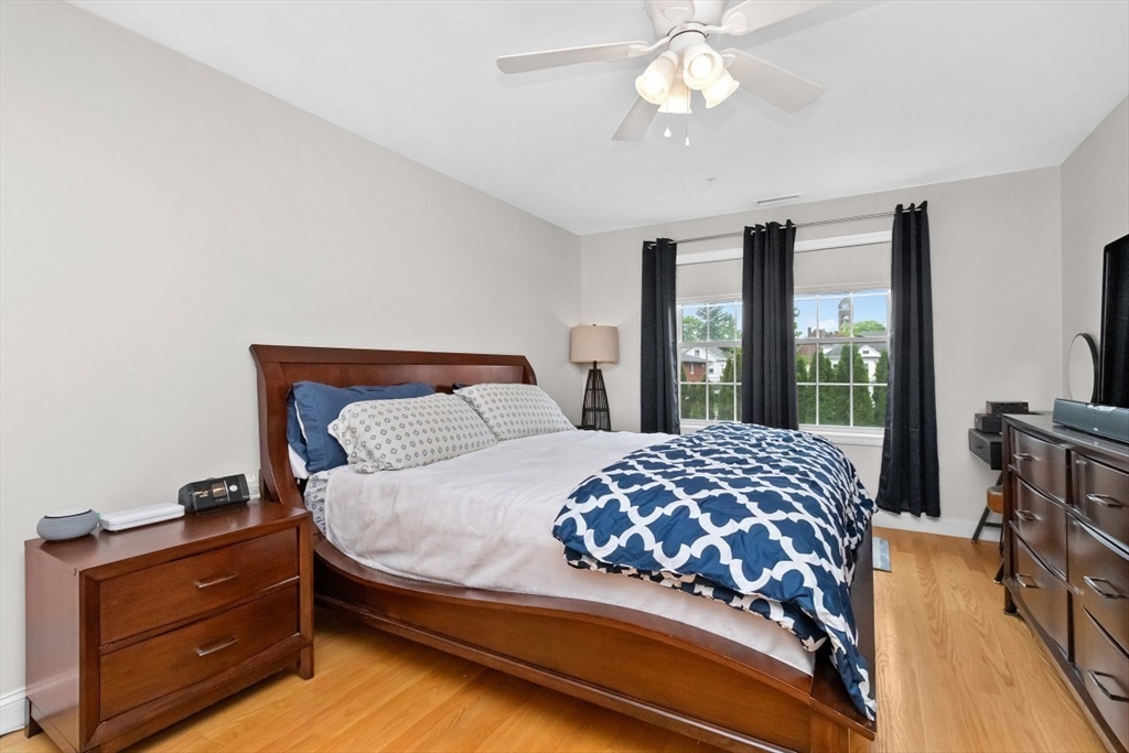 29 Spruce Street, Unit 23 Waltham, MA 02453 - Photo 12 of 26 a bedroom with a bed and large windows