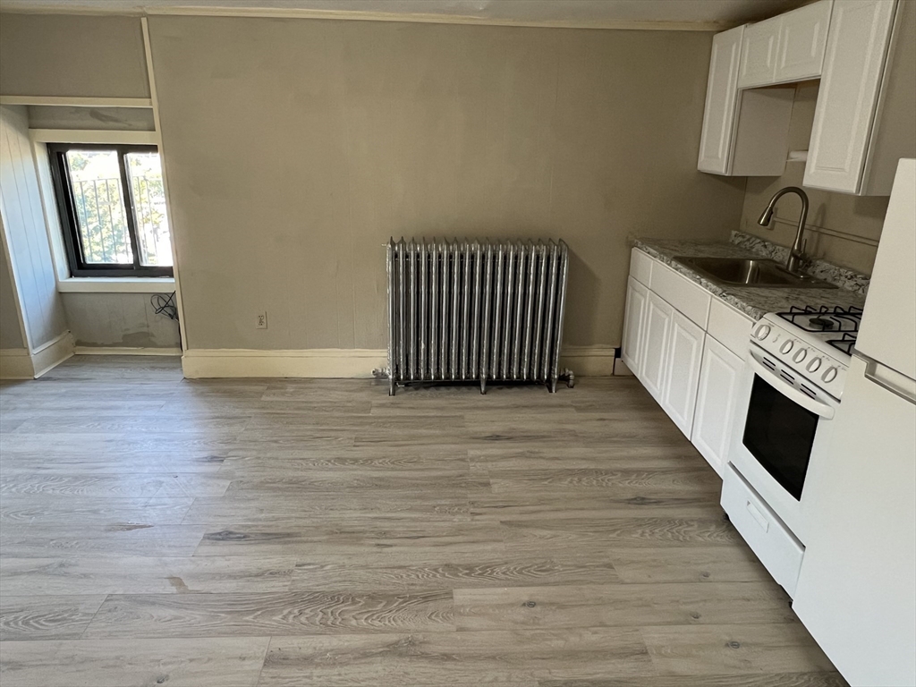 14 Monument Square, Unit 411 Boston, MA 02129 - Photo 3 of 7 a view of a kitchen from an empty room