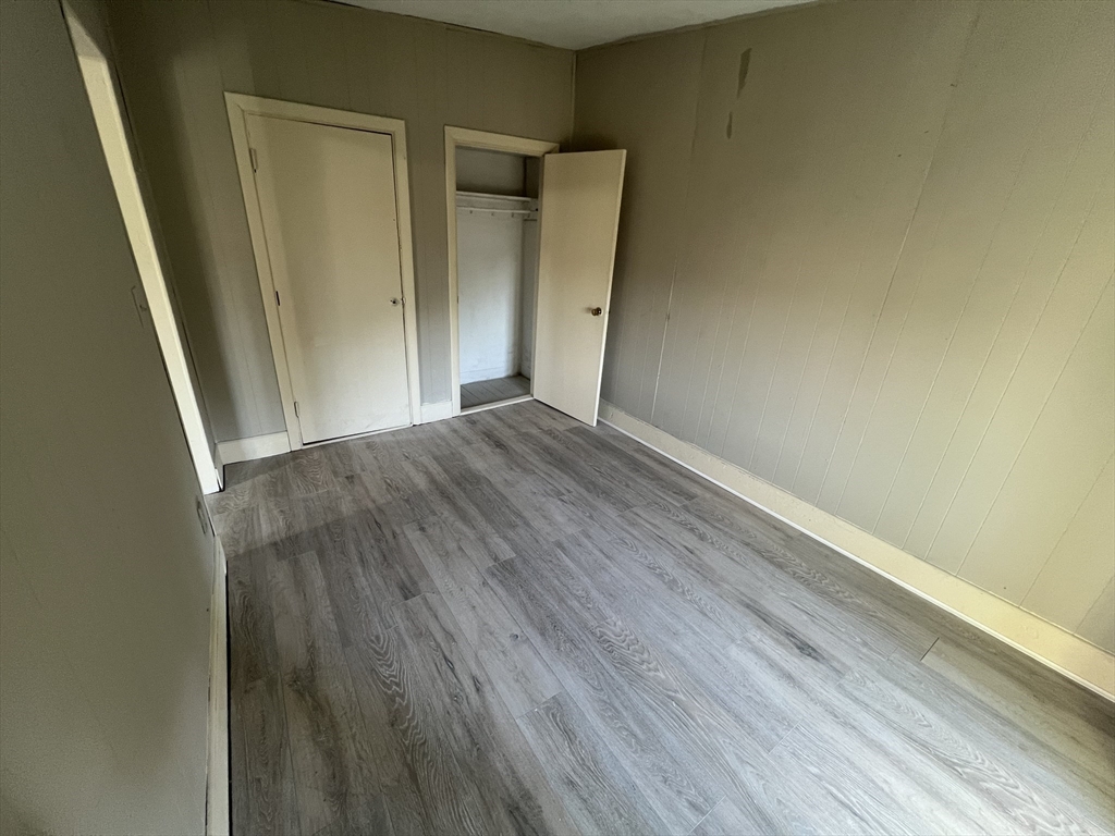 14 Monument Square, Unit 411 Boston, MA 02129 - Photo 5 of 7 a view of an empty room with wooden floor and a window