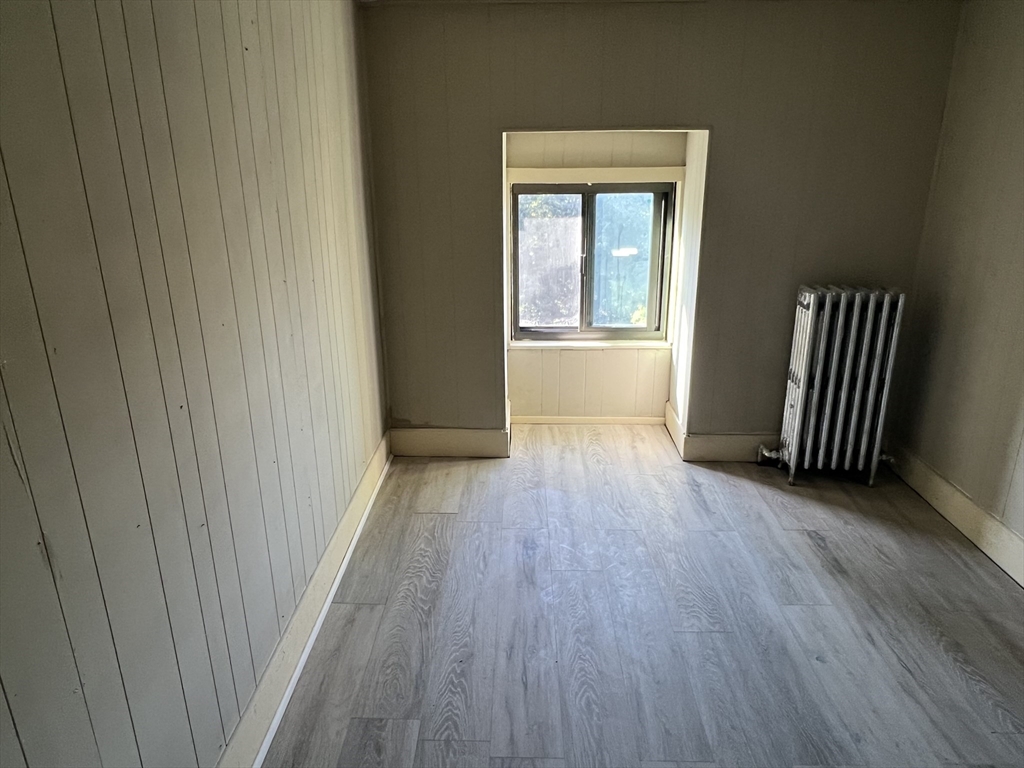 14 Monument Square, Unit 411 Boston, MA 02129 - Photo 6 of 7 a view of a hallway with wooden floor and a window