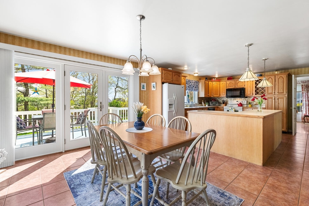 8 Oxford Road Gloucester, MA 01930 - Photo 16 of 35 a dining room with stainless steel appliances a dining table chairs and a floor to ceiling window