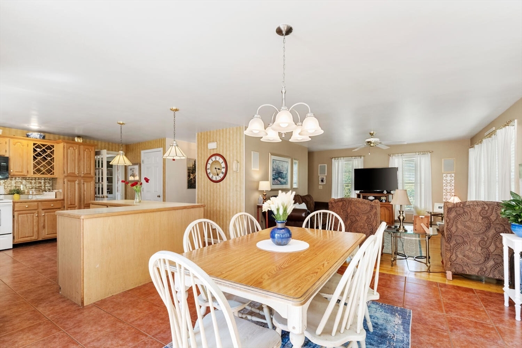 8 Oxford Road Gloucester, MA 01930 - Photo 17 of 35 a view of a dining room and a livingroom with furniture wooden floor a chandelier